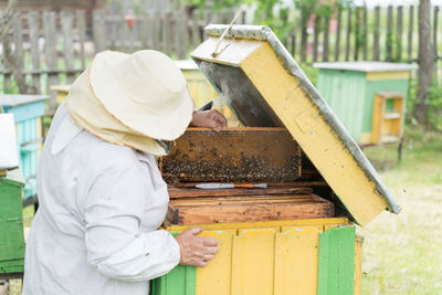 Beekeeper holding tray of honeycomb at park