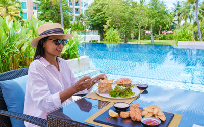 Portrait of smiling young woman having breakfast