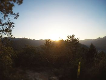 Scenic view of landscape against clear sky during sunset