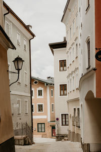 Low angle view of buildings in town against sky