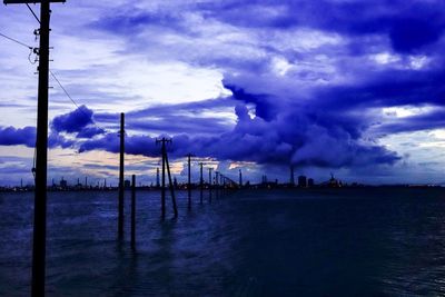 Scenic view of calm sea against cloudy sky