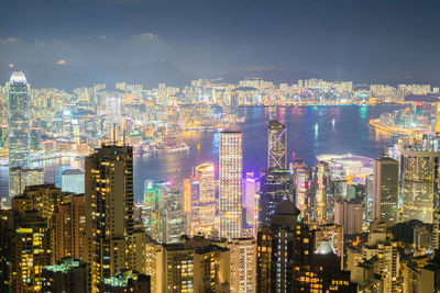 Illuminated cityscape against sky at night