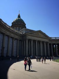 People at kazan cathedral against clear blue sky in city