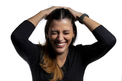 Portrait of smiling young woman against white background