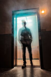 Man standing in illuminated room