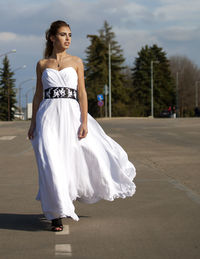 Full length of woman standing on road