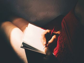 Close-up of hand holding paper at home