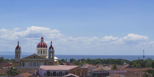 View of houses against blue sky