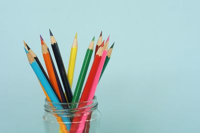 Close-up of multi colored pencils against white background