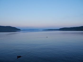 Scenic view of sea against clear sky during sunset