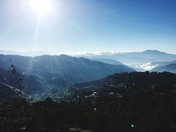 Scenic view of mountains against sky on sunny day