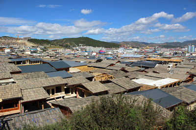 High angle view of townscape by sea against sky