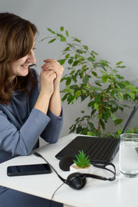 Woman using smart phone on table