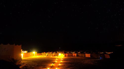 Illuminated building against sky at night