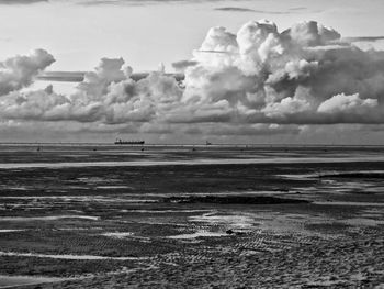 Scenic view of sea against cloudy sky