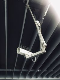 Low angle view of electric lamp hanging from ceiling