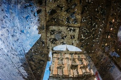 Reflection of building in puddle