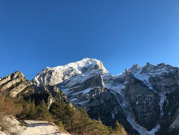 Scenic view of snowcapped mountains against clear blue sky