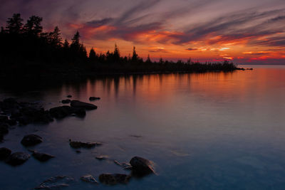 Scenic view of lake at sunset