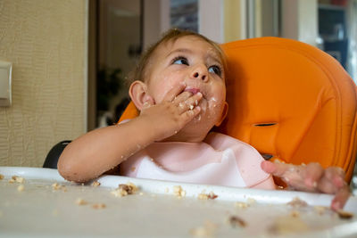 Cute girl eating food at home