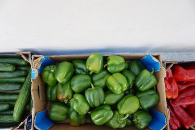 Directly above shot of green bell peppers in box