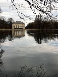 Scenic view of lake by building against sky