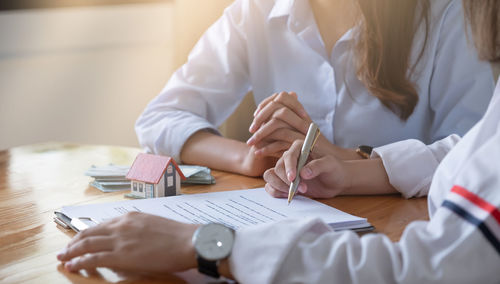 Woman signing contract at office