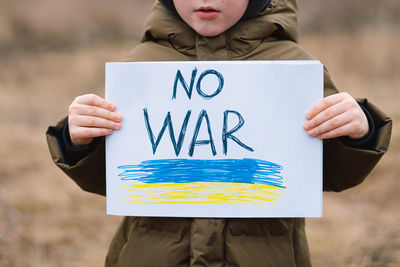 War of russia against ukraine. crying boy asks to stop the war in ukraine.