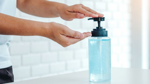 Close-up of hand holding glass bottle