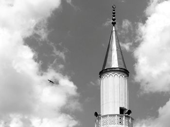 Low angle view of bird flying against sky