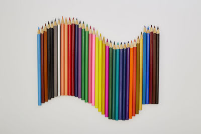 Close-up of multi colored pencils against white background