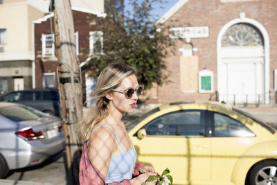 Young woman walking along a street