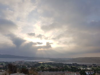 Cityscape against cloudy sky