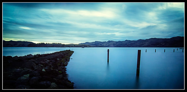 Scenic view of lake against cloudy sky