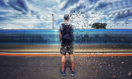 Man standing on train against sky