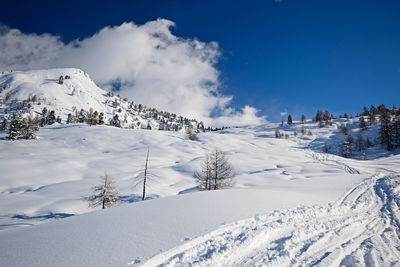 Snow covered landscape against sky