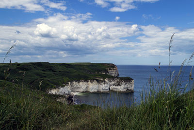 Scenic view of sea against cloudy sky