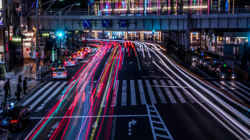 High angle view of light trails on road in city at night