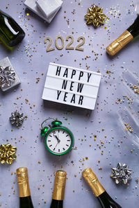 New year pattern with champagne glasses, bottles, sparkles, confetti and number of 2022. 