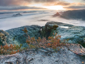 Scenic view of rocks against sky during sunset