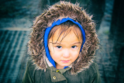 Close-up portrait of cute girl wearing fur coat