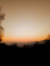 Scenic view of silhouette trees against sky during sunset