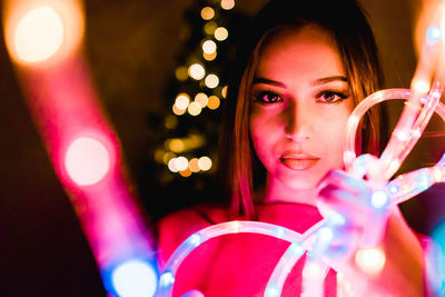Portrait of teenage girl with illuminated lights