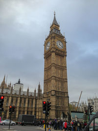 Clock tower in city against sky