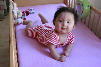 Portrait of baby lying in crib