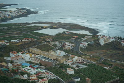 High angle view of buildings and sea in city