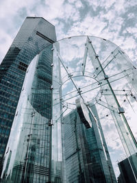 Digital composite image of modern building against cloudy sky