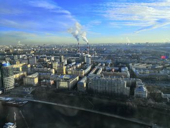 Aerial view of buildings in city against sky