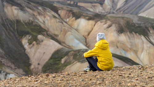 Hiker is taking a break to enjoy iceland's scenic highlands