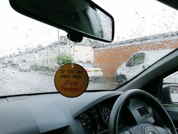 Close-up of information sign on car window